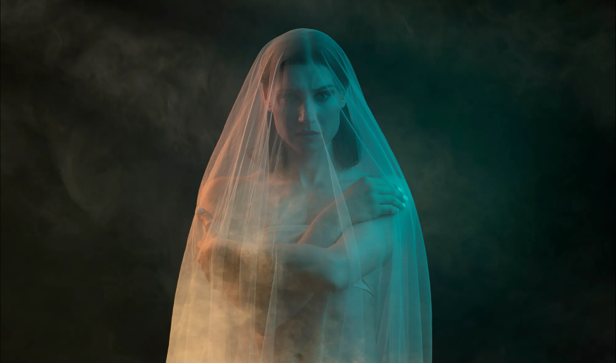 Ania Nova beneath a sheer veil in drifting smoke